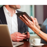 Man & Woman with laptop, cellphone, and tablet.